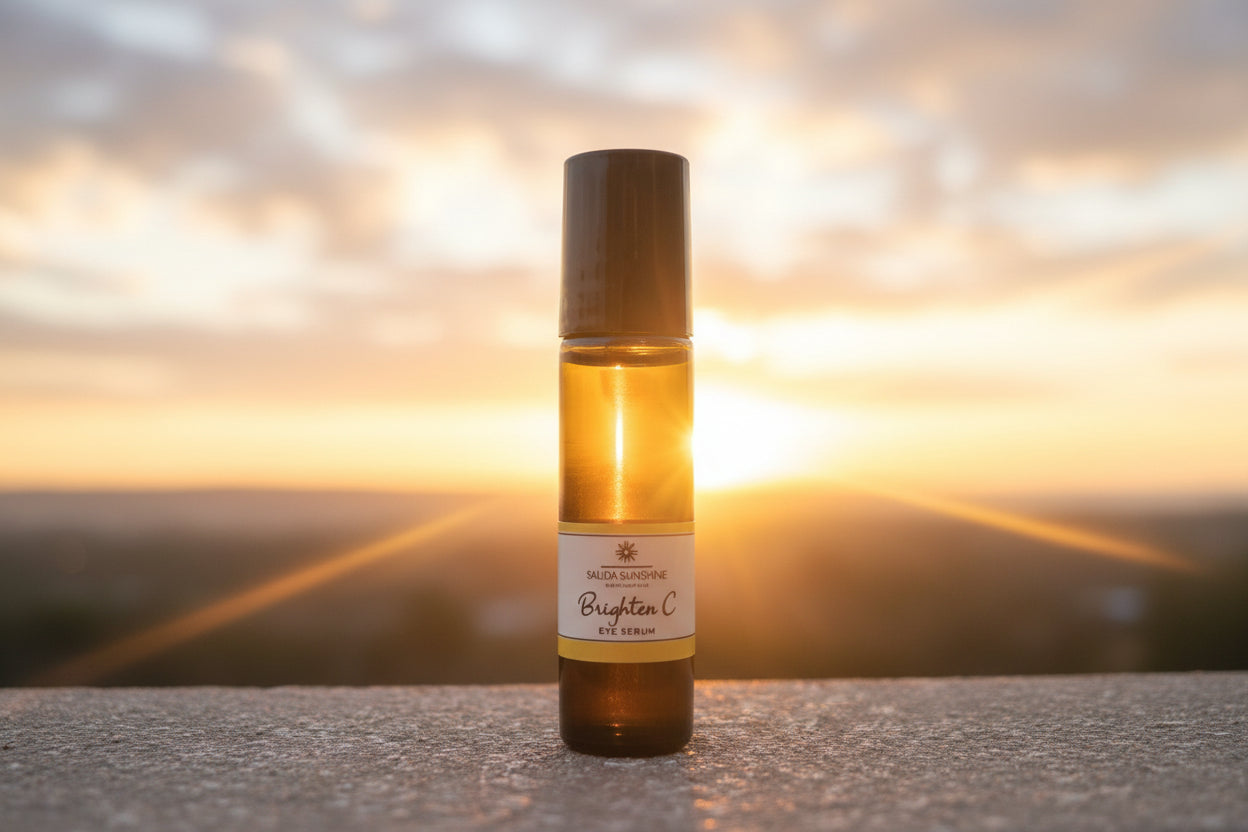 Small bottle with a black cap and yellow label on green leaves